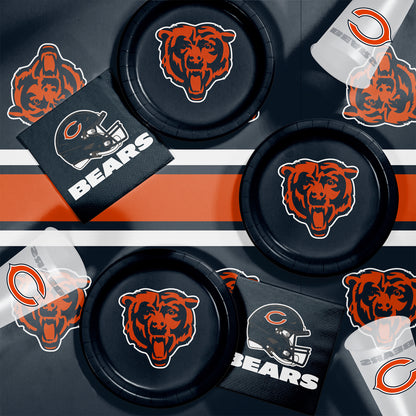 Collection of Chicago Bears-themed items including plates, napkins and cups on a dark background.