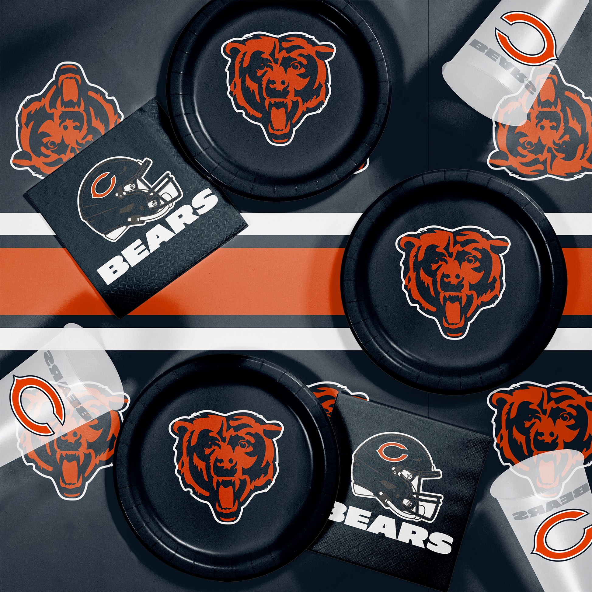 Collection of Chicago Bears-themed items including plates, napkins and cups on a dark background.