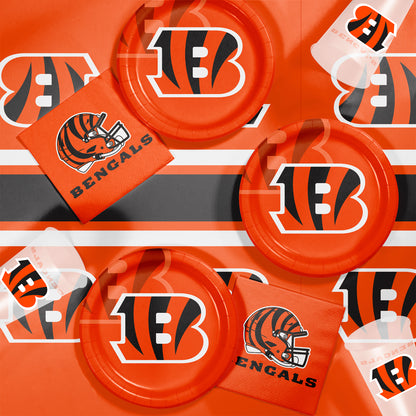 Bengals-themed party supplies including plates, napkins, and cups on a matching background.