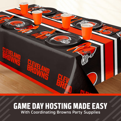 Cleveland Browns themed party table setting with a printed tablecloth, matching plates, cups, and utensils, shown on a table with a promotional banner at the bottom that says "Game Day Hosting Made Easy".