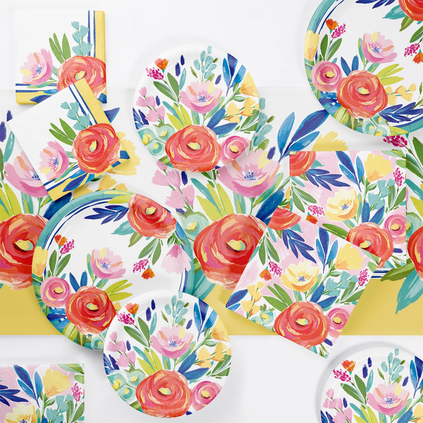 Floral-patterned paper plates and cups on a matching floral tablecloth