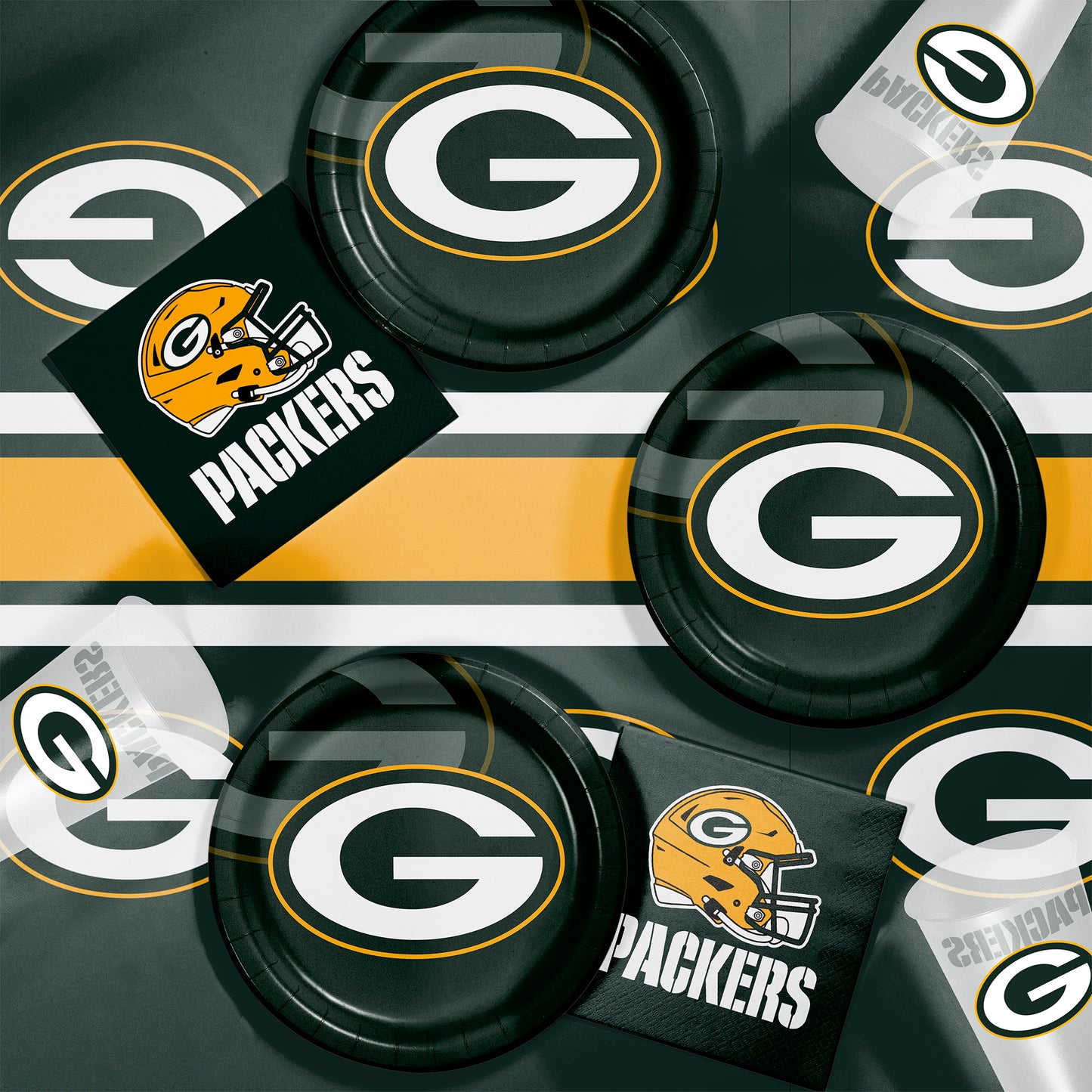 Green Bay Packers plates, napkins and cups displayed on a matching tablecloth