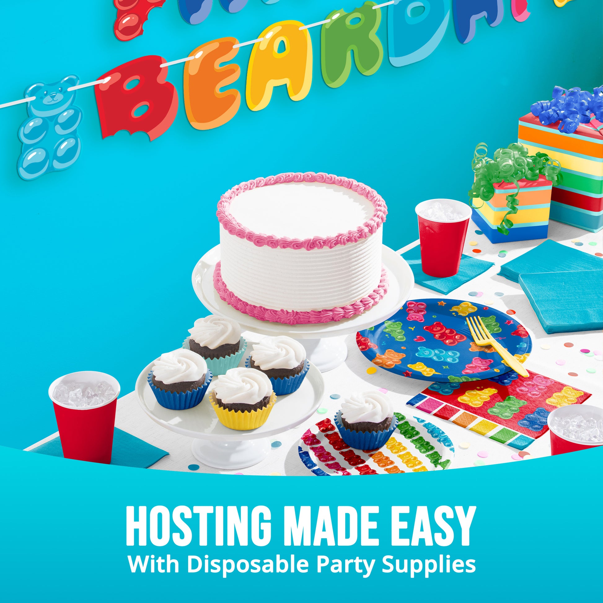 Birthday party setup with cake, cupcakes, and decorations against a blue background.