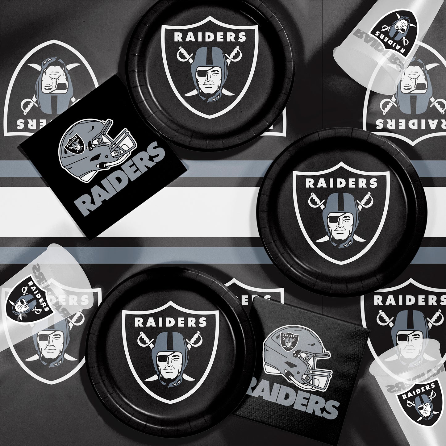 Las Vegas Raiders plates, napkins and cups displayed on a matching tablecloth