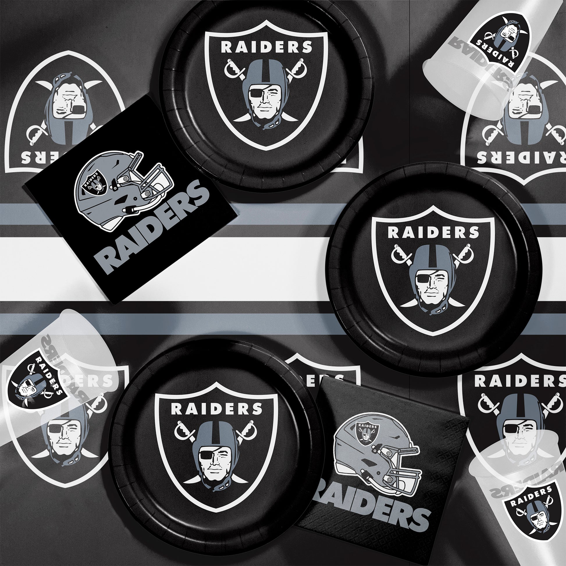 Las Vegas Raiders plates, napkins and cups displayed on a matching tablecloth