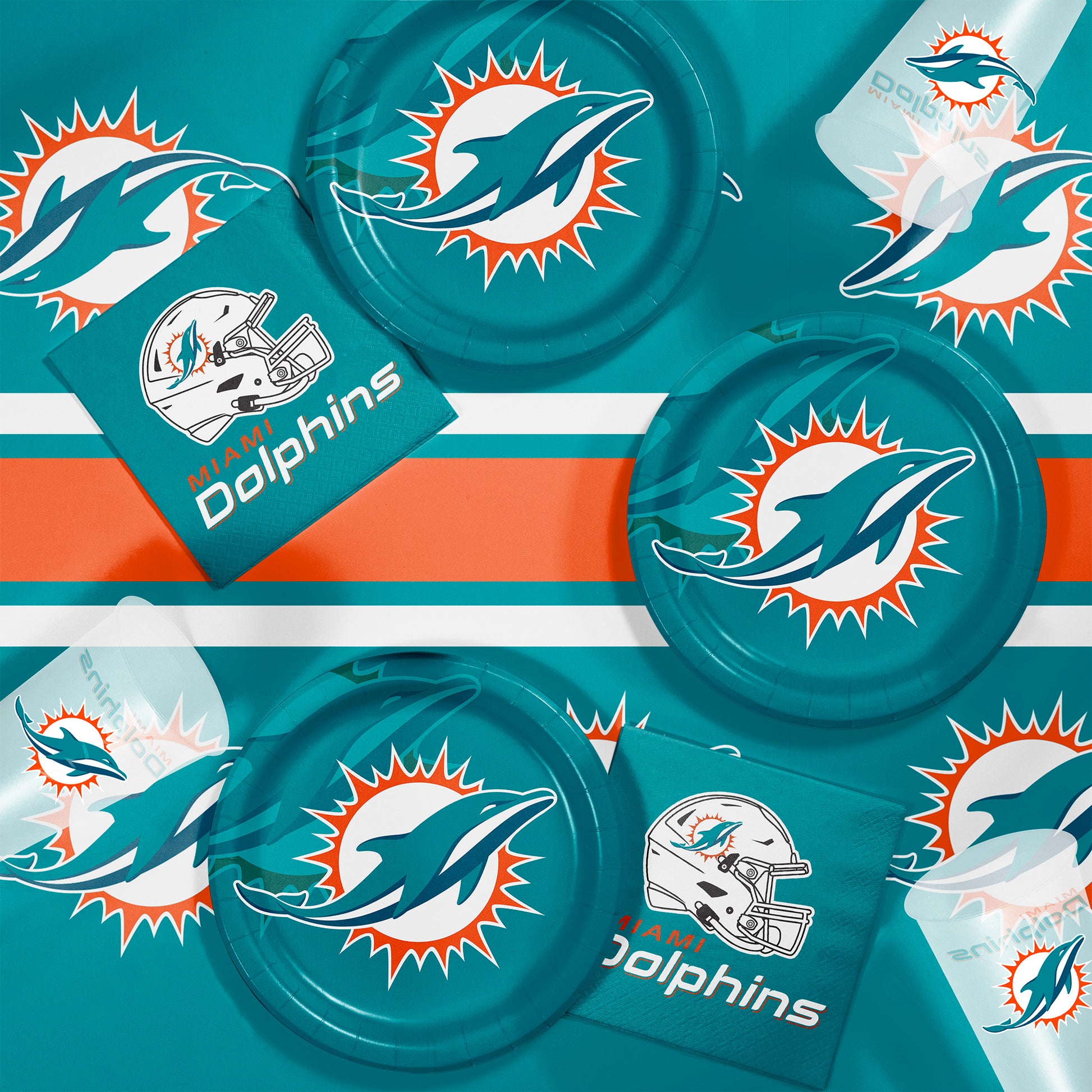 Miami Dolphins plates, napkins and cups displayed on a matching tablecloth