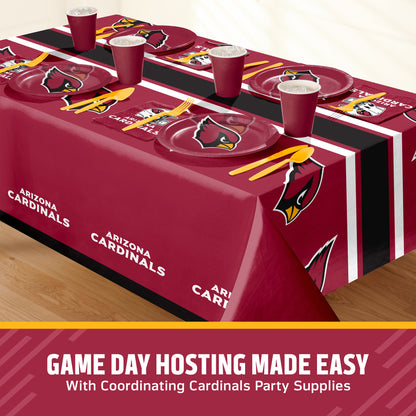 Arizona Cardinals themed party table setting with a maroon tablecloth, matching plates, cups, and yellow utensils, shown on a table with a promotional banner at the bottom with "Game Day Hosting Made Easy with Coordinating Cardinals Party Supplies" text.