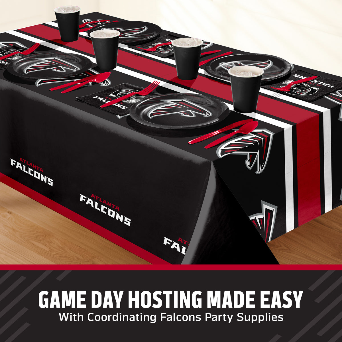 Atlanta Falcons themed party tablecloth and matching tableware set, including black plates, cups, napkins, and placemats with red and white branding, displayed on a table with a promotional banner at the bottom with "Game Day Hosting Made Easy" text.