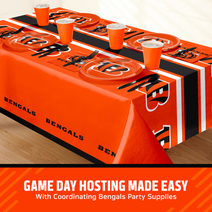 Cincinnati Bengals themed party table setting with a printed tablecloth, matching plates, cups, and utensils, shown on a table with a promotional banner at the bottom that says "Game Day Hosting Made Easy".