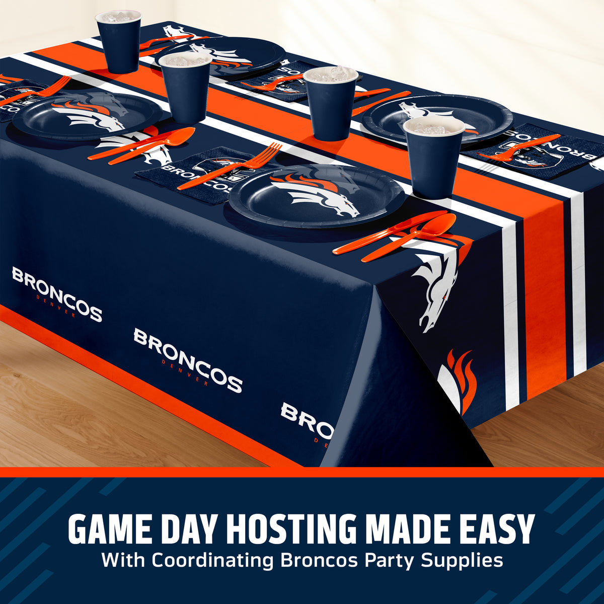 Denver Broncos themed party table setting with a printed tablecloth, matching plates, cups, and utensils, shown on a table with a promotional banner at the bottom that says "Game Day Hosting Made Easy".