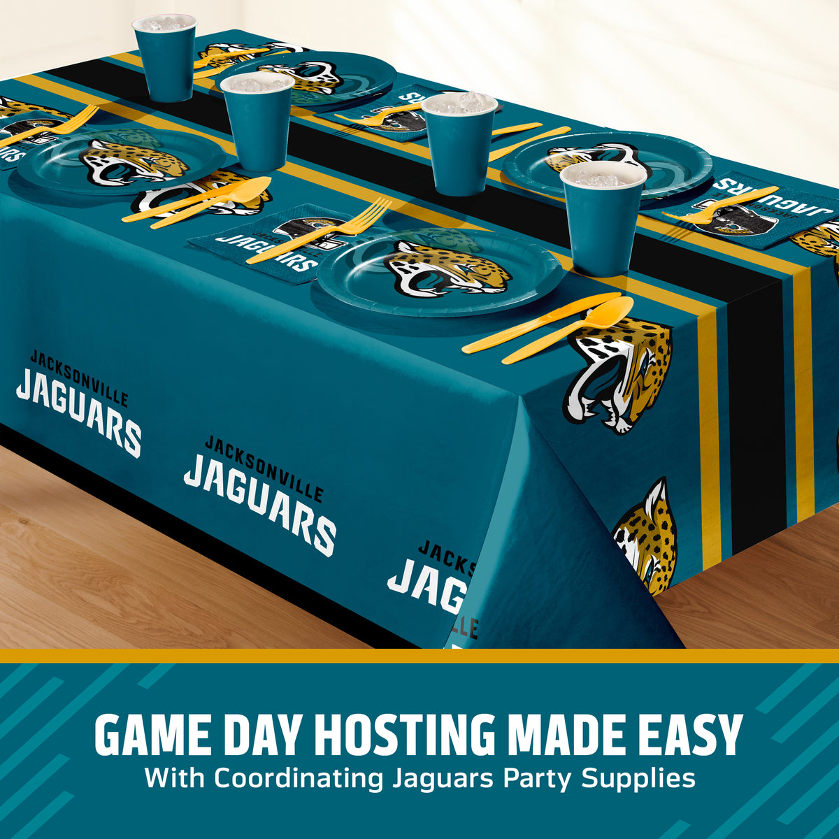 A Jacksonville Jaguars themed party table setting featuring a teal, black, and gold printed tablecloth, matching plates, cups, and utensils, displayed on a wooden floor with a promotional banner at the bottom with 'GAME DAY HOSTING MADE EASY' text.