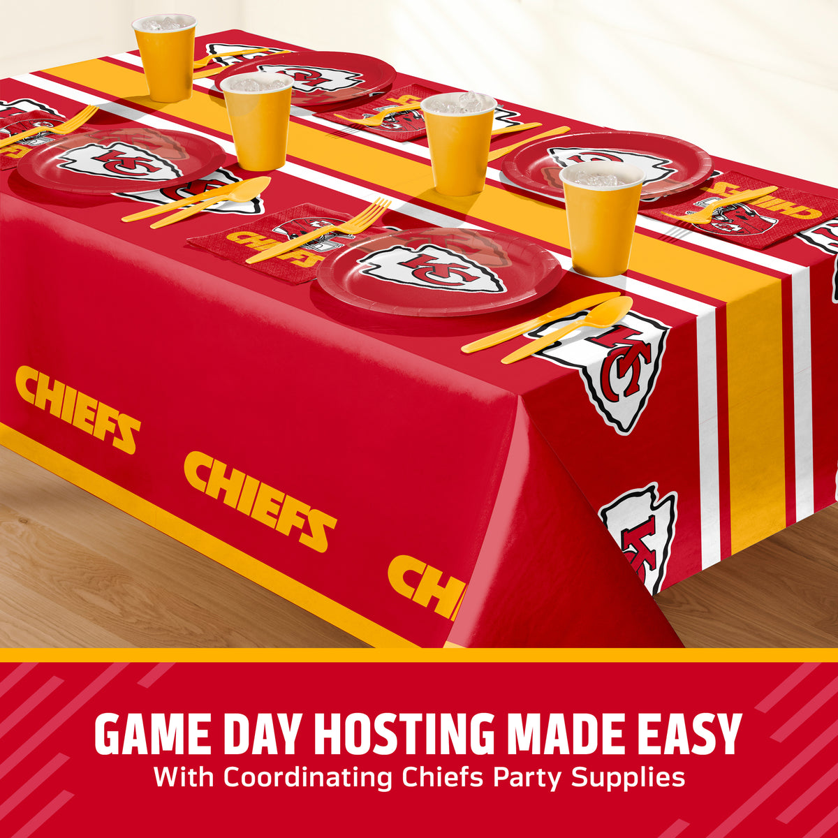 Kansas City Chiefs themed party table setting with a printed tablecloth, matching plates, cups, and utensils, shown on a table with a promotional banner at the bottom that says "Game Day Hosting Made Easy".
