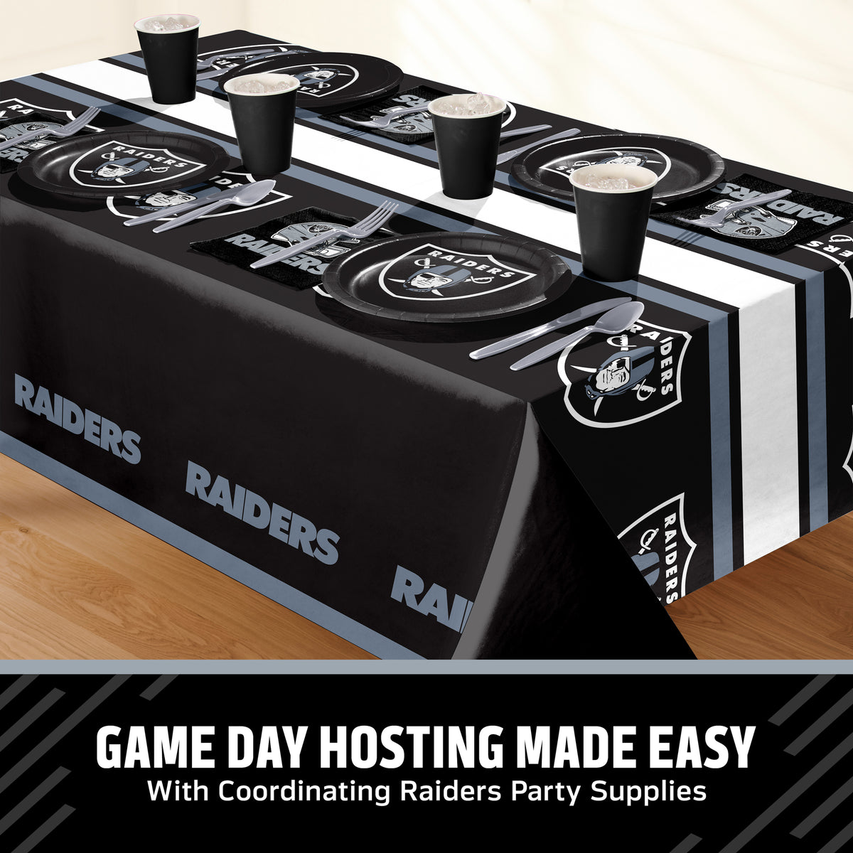 Las Vegas Raiders themed party table setting with a printed tablecloth, matching plates, cups, and utensils, shown on a table with a promotional banner at the bottom that says "Game Day Hosting Made Easy".