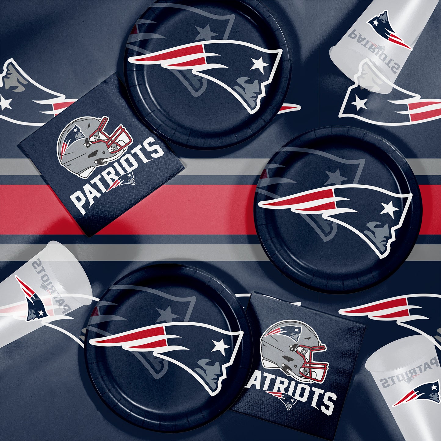 New England Patriots party supplies including plates, napkins, and cups on a dark background.