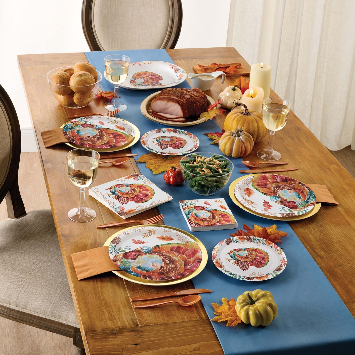 Tasteful Turkey Dinner Napkins 192 ct displayed on a wooden table with autumn decorations and tableware