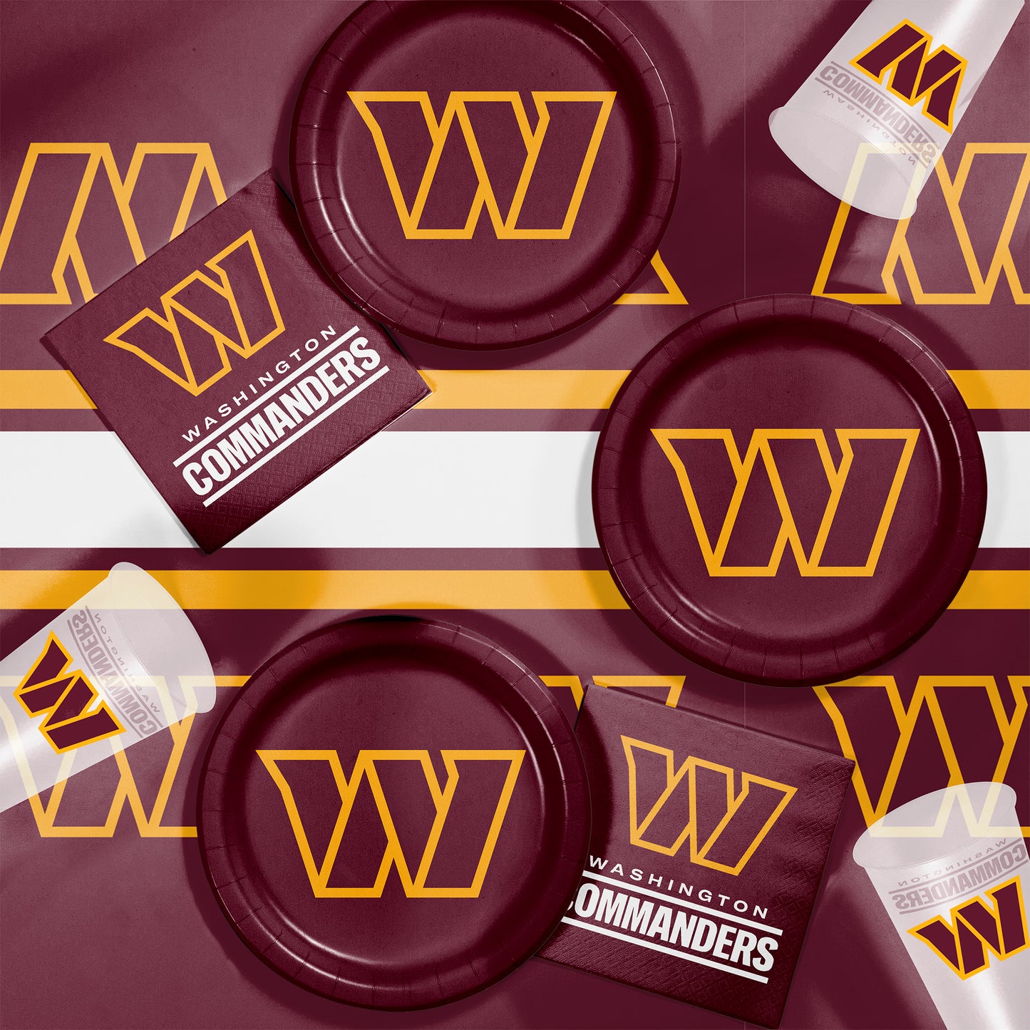Washington Commanders plates, napkins and cups displayed on a matching tablecloth